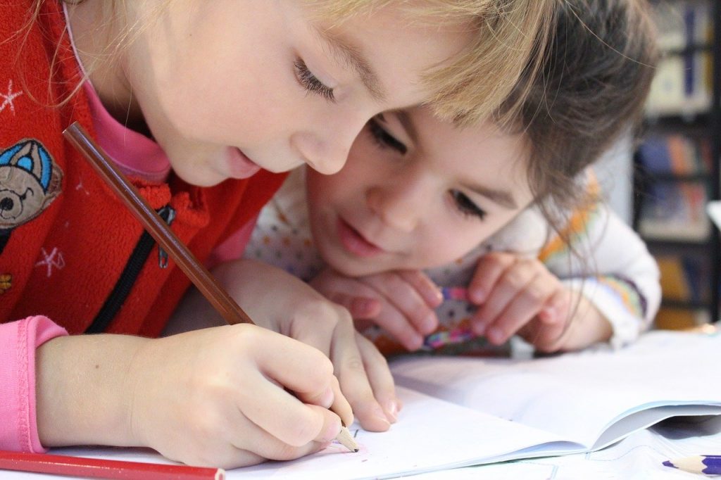 a child writing on a piece of paper