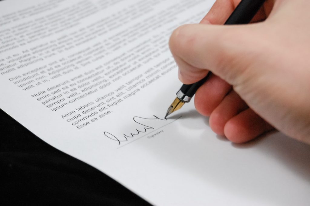 a person writing on a piece of paper