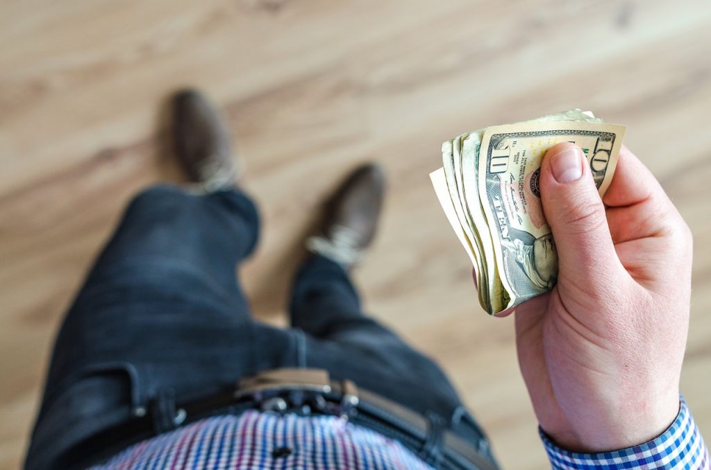 a person holding a cash register