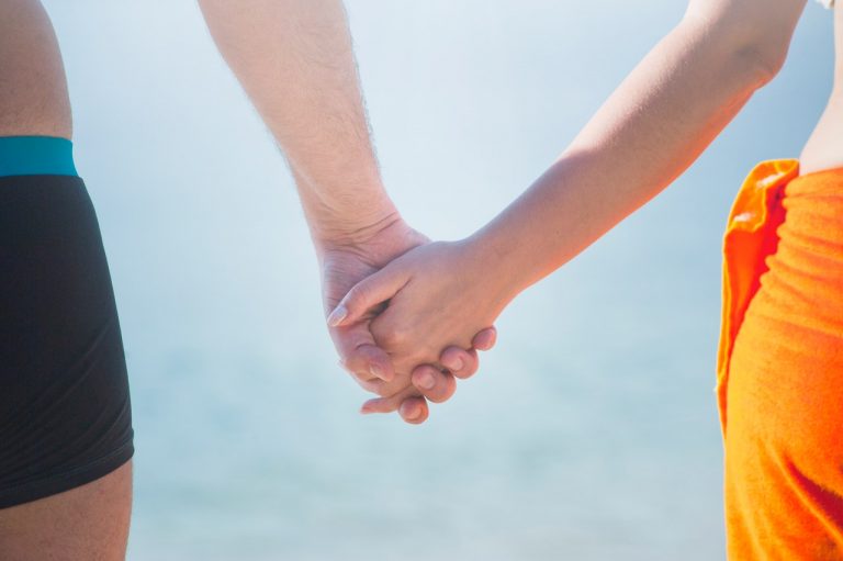 a man and woman holding hands