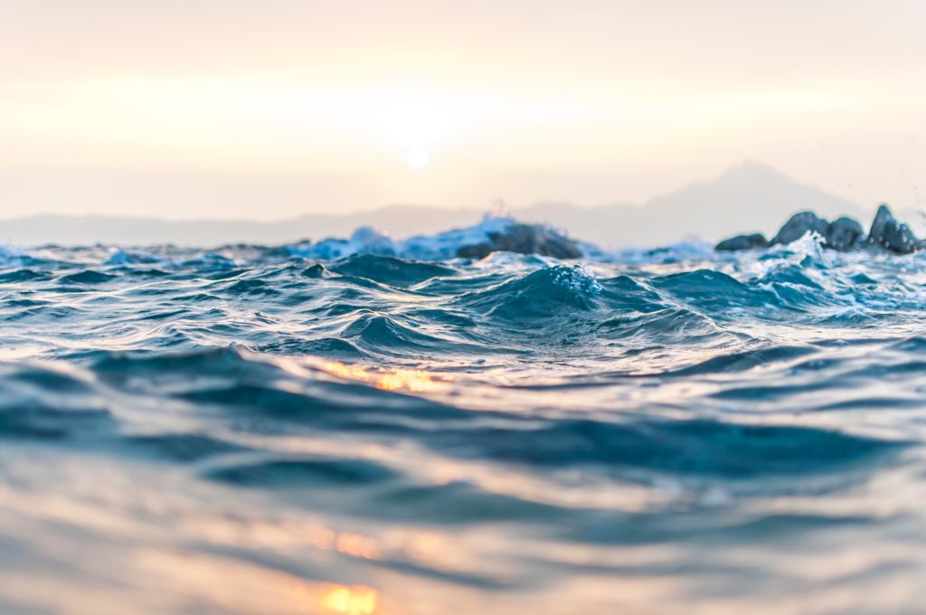 a body of water with mountains in the background