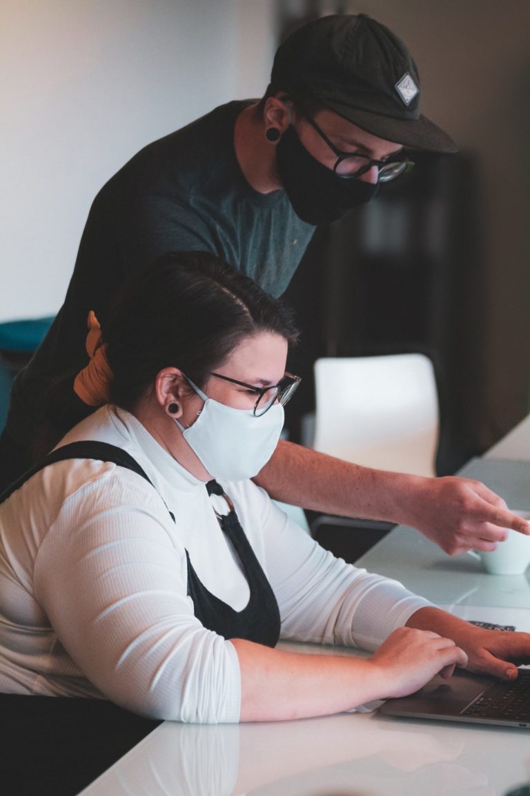 a man and a woman looking at a computer screen