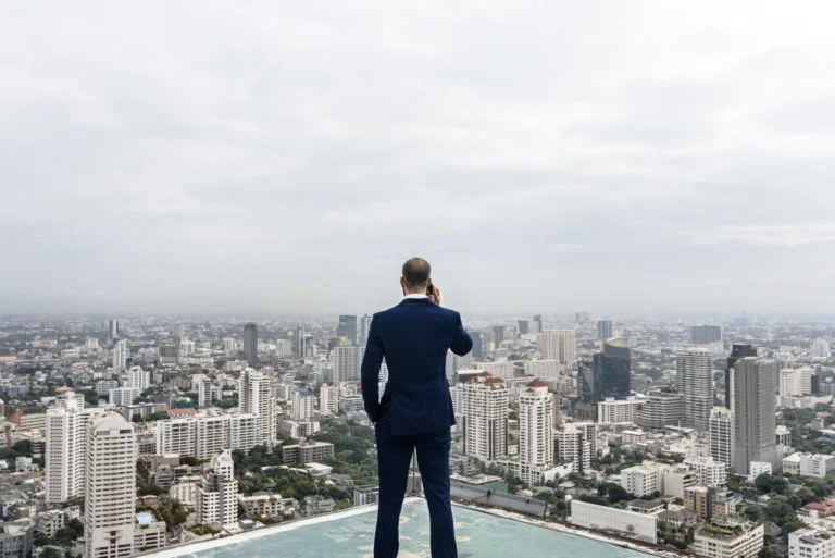 a person standing on a rooftop overlooking a city
