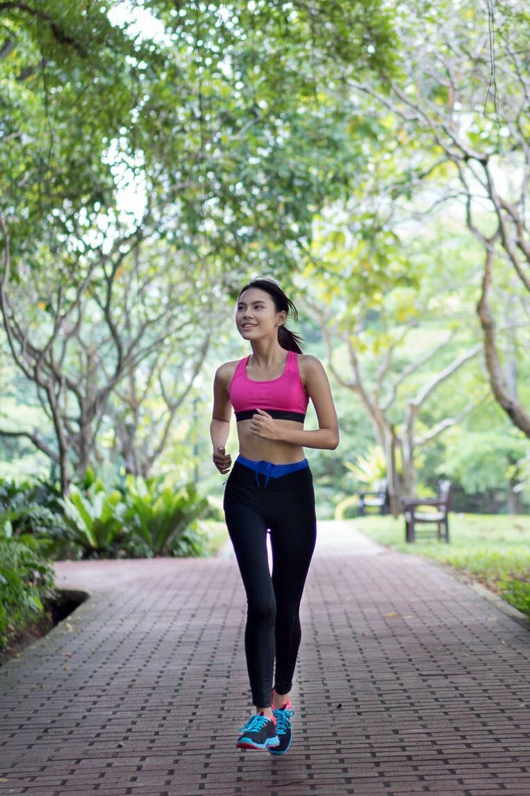 a woman running on a path