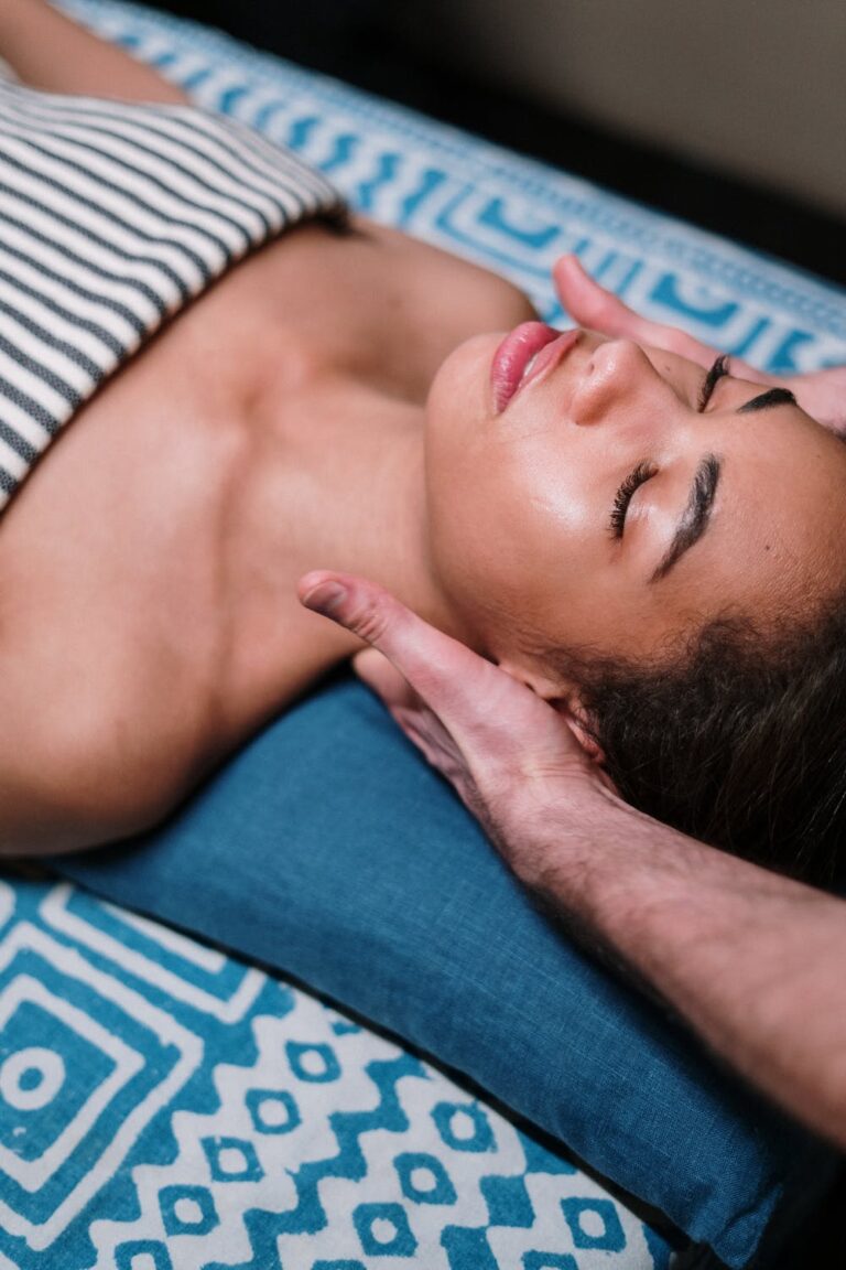 a man lying down with his hand on his face