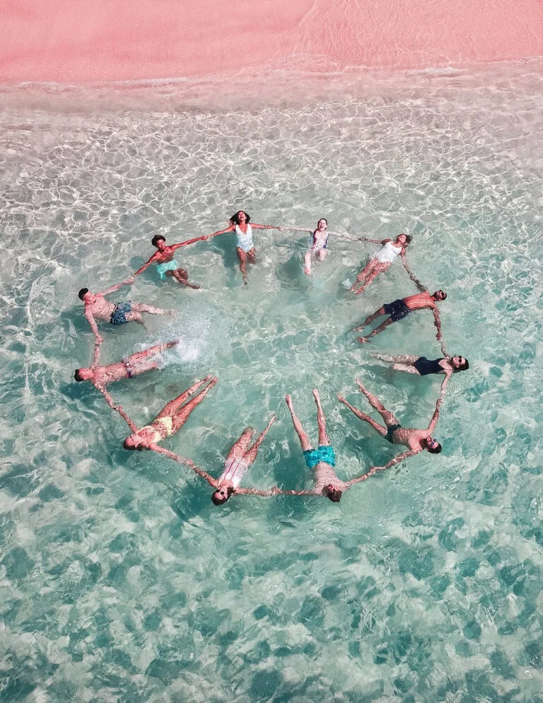 a group of people in a body of water with a rope attached to their feet